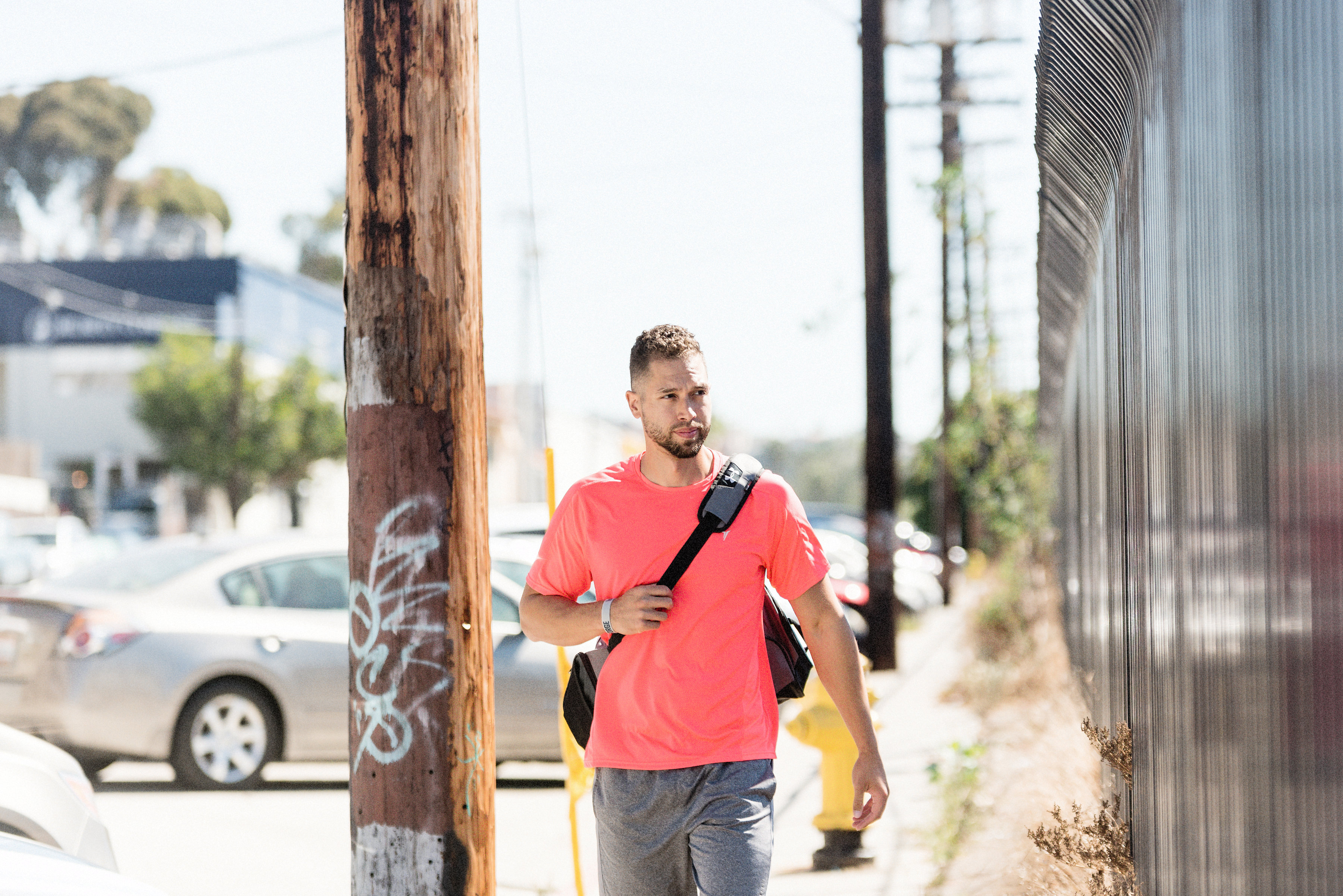 Mitchell Arce walking with purpose down a city street